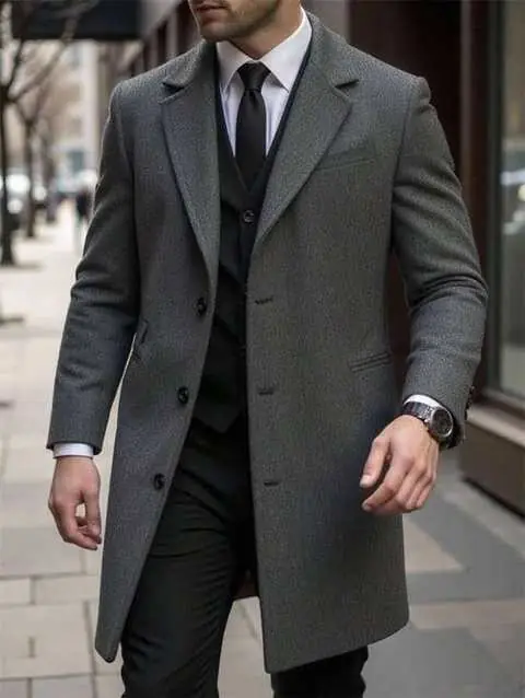 Model in grey wool overcoat over black three-piece suit