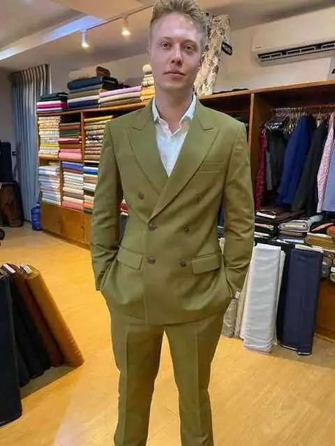 Client in olive green double-breasted bespoke suit