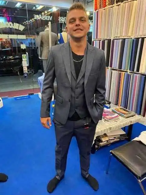 Client in charcoal grey three-piece bespoke suit at Paul Bespoke Tailor