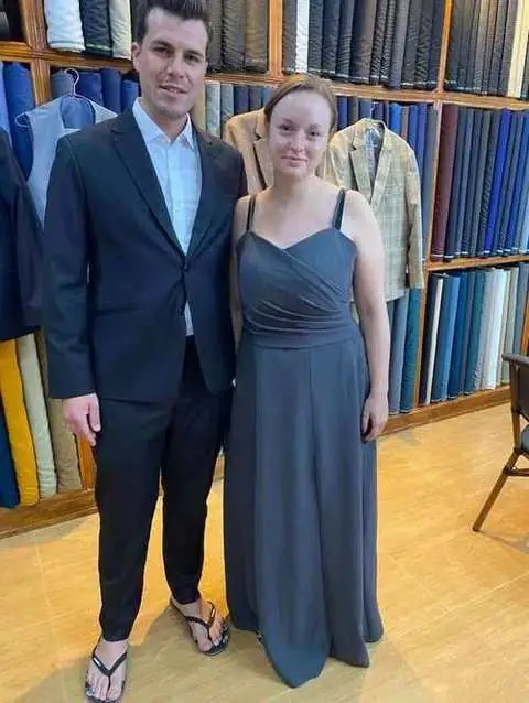 Couple in formal wear, navy tailored suit and charcoal grey evening gown