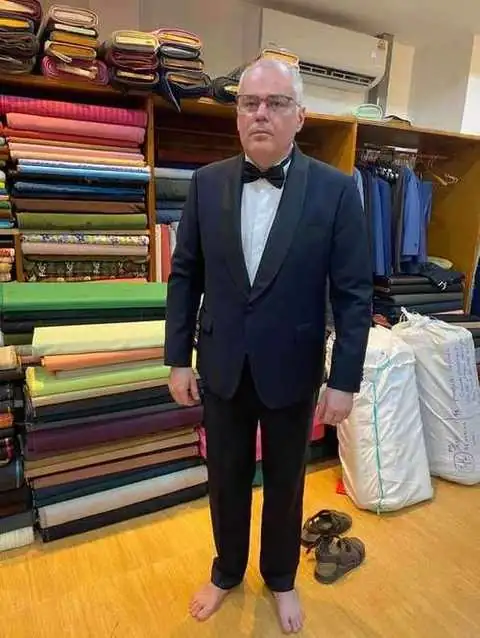 Client in navy tuxedo with black bow tie