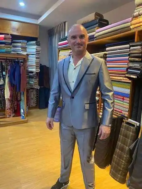 Client in metallic silver-grey suit with satin lapels