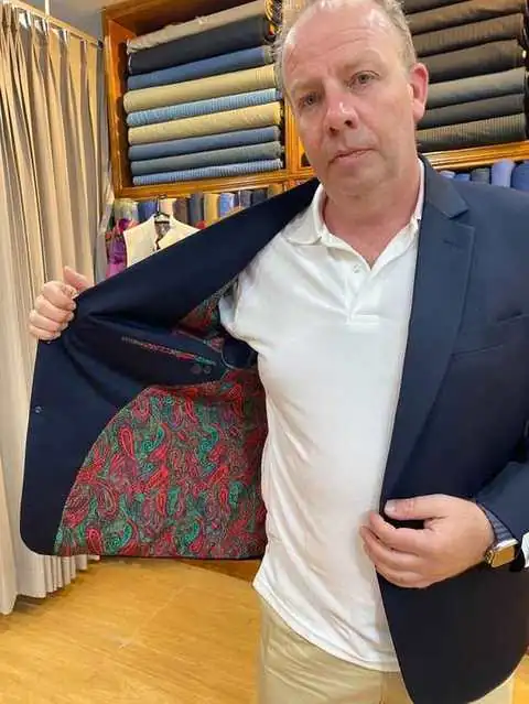 Client showing the colorful paisley lining inside a navy blazer