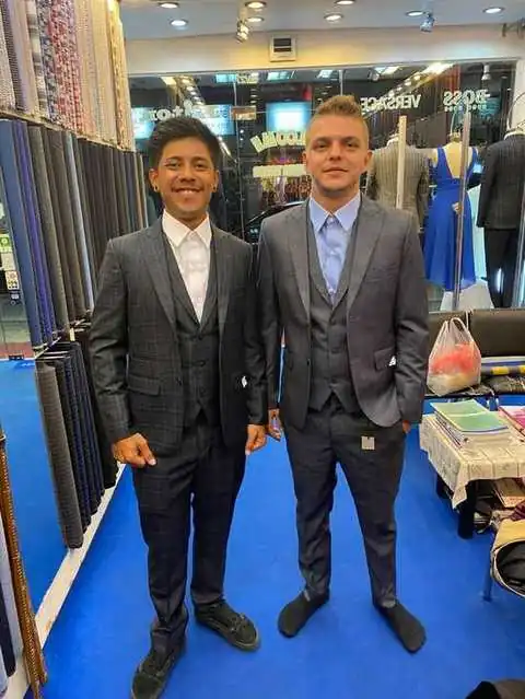Two clients in matching grey plaid three-piece suits