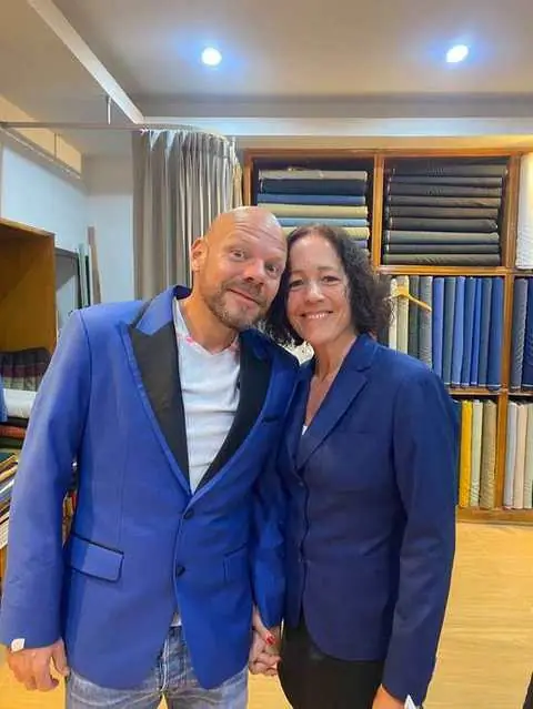 Couple in matching blue tailored blazers