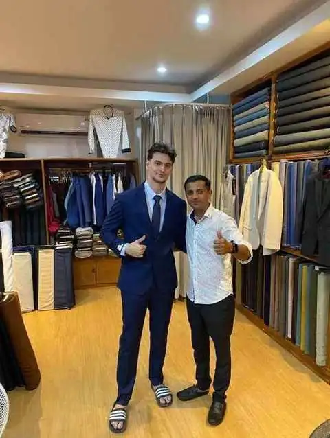 Two clients in navy suit and patterned shirt at the fitting shop