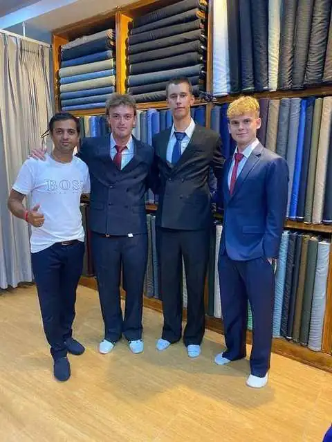 Four clients in matching navy pinstripe and navy suits