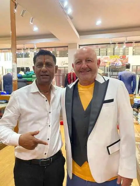 Two clients, one in a white tuxedo jacket with black lapels