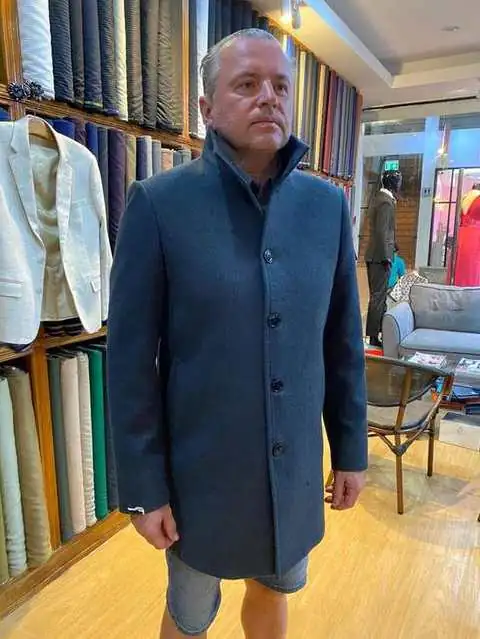 Client in dark teal wool overcoat