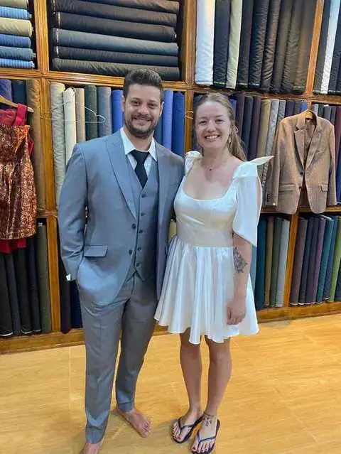 Couple dressed formally, grey three-piece suit and white satin dress