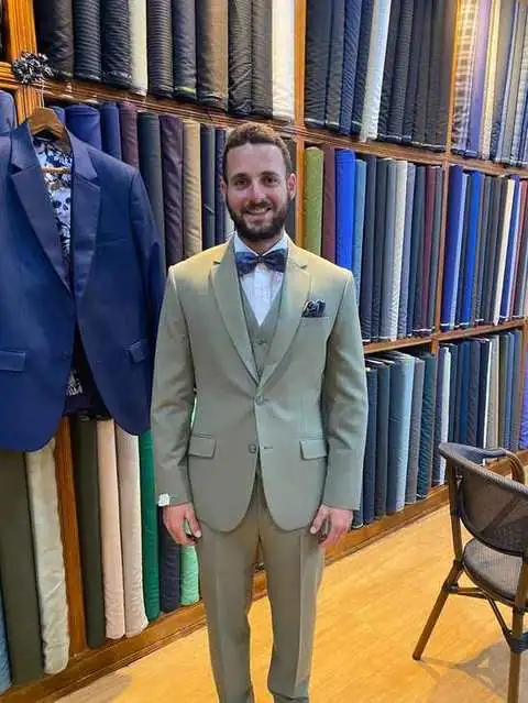 Client in olive green three-piece suit with bow tie