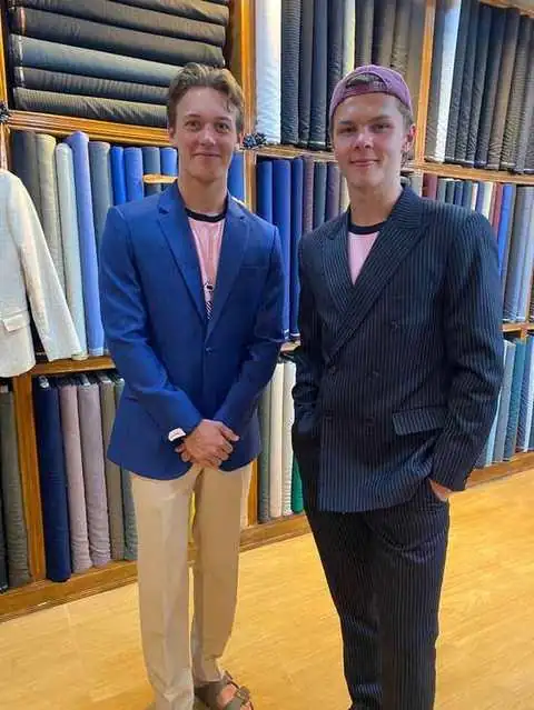 Two clients in a blue blazer and a navy pinstripe suit