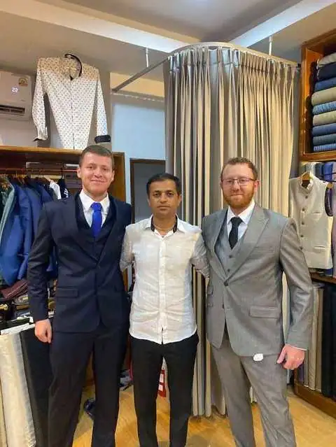 Three clients in navy suit, white shirt, and grey three-piece suit