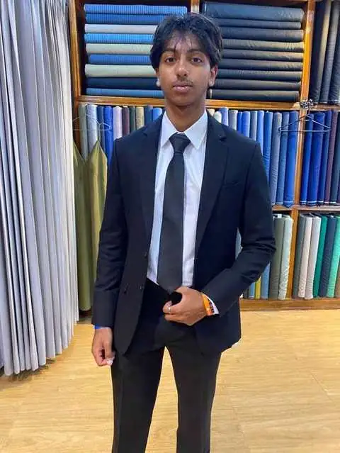 Client in a black suit with tie
